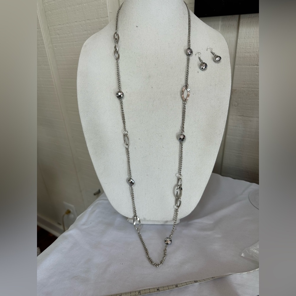 Long silvertone statement necklace with earrings